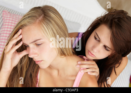 Teenage girl comforting friend Stock Photo