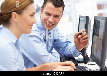 Business man and woman working on computers Stock Photo