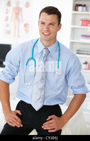 Young male doctor in consulting room Stock Photo