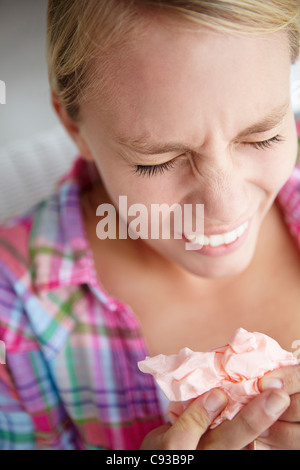Teenage girl sneezing Stock Photo