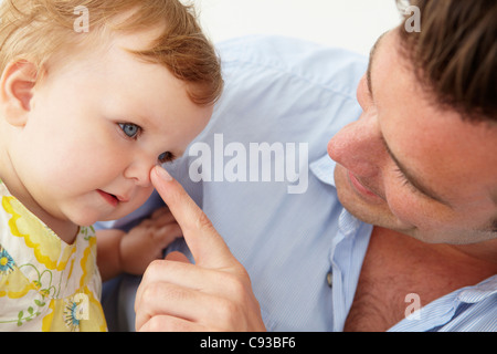 Doting father with baby daughter at home Stock Photo