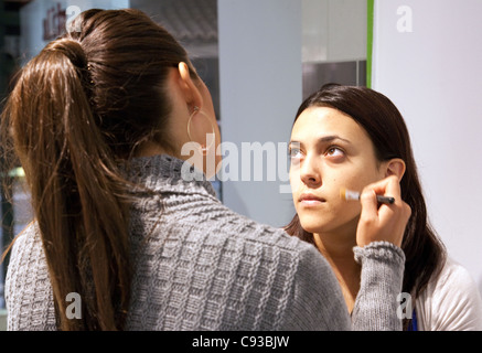 A make up artiste applying make up to the face of a teenage girl,  Washington DC USA Stock Photo