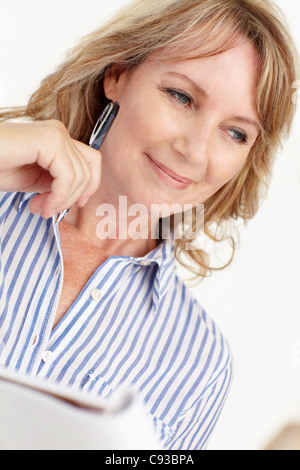 Mid age businesswoman at work Stock Photo