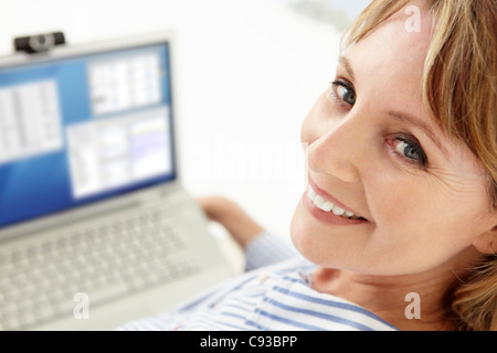 Mid age businesswoman using laptop Stock Photo