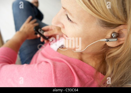 Senior woman wearing earphones Stock Photo