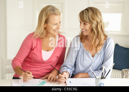 Mid age women painting with watercolors Stock Photo