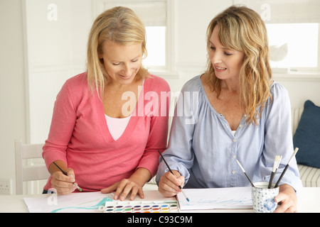 Mid age women painting with watercolors Stock Photo
