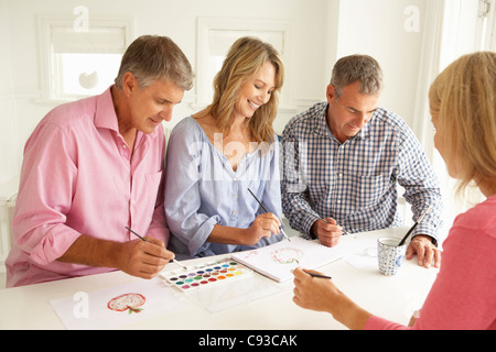 Mid age couples painting with watercolors Stock Photo