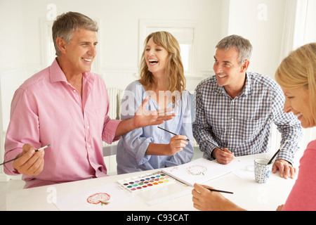 Mid age couples painting with watercolors Stock Photo