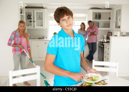 Teenagers not enjoying housework Stock Photo