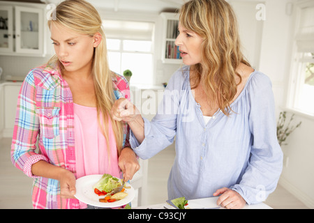 Mother and teenage daughter arguing about housework Stock Photo