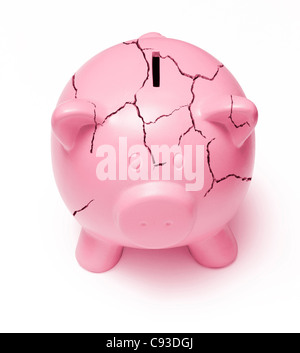 Cracked pink piggy bank on a white background signifying the poor state of the economy Stock Photo