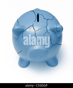 Cracked blue piggy bank on a white background signifying the poor state of the economy Stock Photo