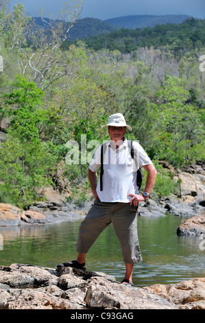 Male Tourist standing in front of rock pool on Alligator Creek, Bowling Green Bay National Park, Townsville, Queensland, Australia Stock Photo