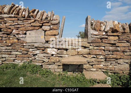 A local stone public footpath stile on a south coast path (South Dorset Ridgeway) in Dorset, UK. Stock Photo