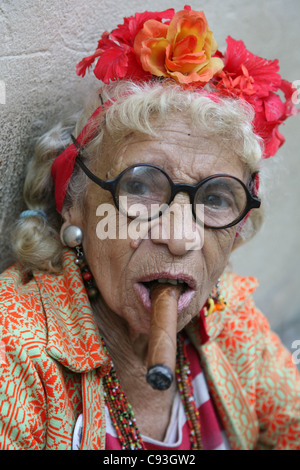 Eccentric elderly Cuban woman Graciela Gonzalez also known as Granny Puretta smokes cigar at age 84 in the historical centre in Havana, Cuba. Stock Photo