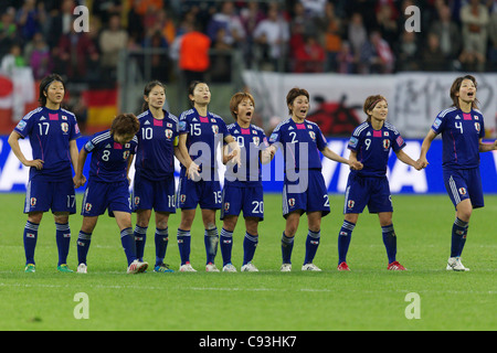 Japan players react to a teammate's score in the penalty kick shootout of the 2011 Women's World Cup final against the USA. Stock Photo