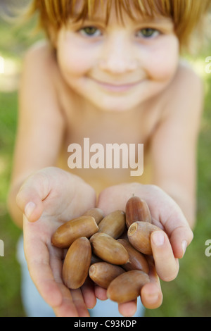 Little boy with acorns Stock Photo