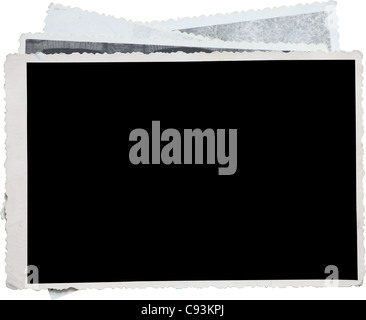 Blank photo frame on a stack of old photos. Clipping path included for eassy issolation Stock Photo