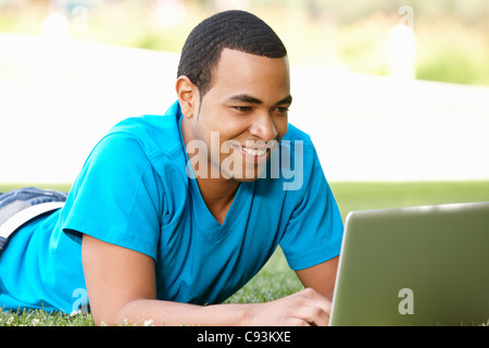Young man using laptop outdoors Stock Photo