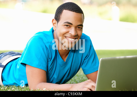Young man using laptop outdoors Stock Photo