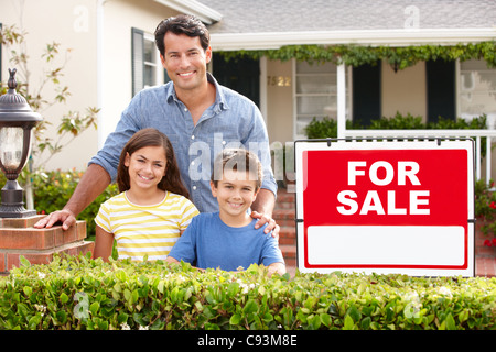 Father and children outside home for sale Stock Photo