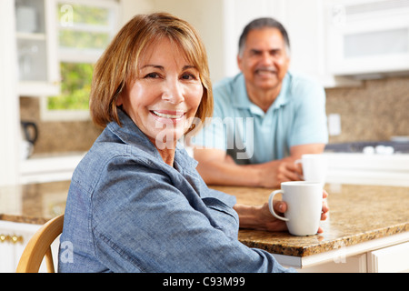 Senior couple relaxing in kitchen Stock Photo