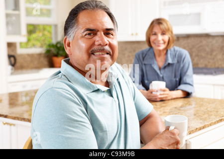 Senior couple relaxing in kitchen Stock Photo