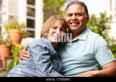 Older couple relaxing in lawn chairs by pool Stock Photo - Alamy