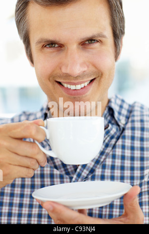 Man relaxing with cup of tea Stock Photo