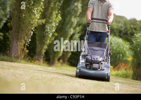 Man mowing lawn Stock Photo