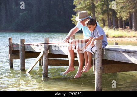Senior man fishing with grandson Stock Photo