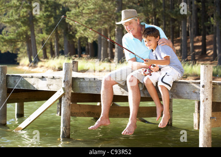 Senior man fishing with grandson Stock Photo