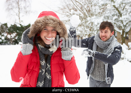 Young couple having snowball fight Stock Photo