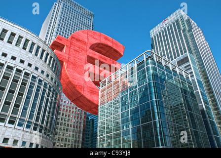 Digitally altered Photograph by hitandrun media. A Giant Euro symbol, floating between buildings in Canary Wharf, London. Stock Photo