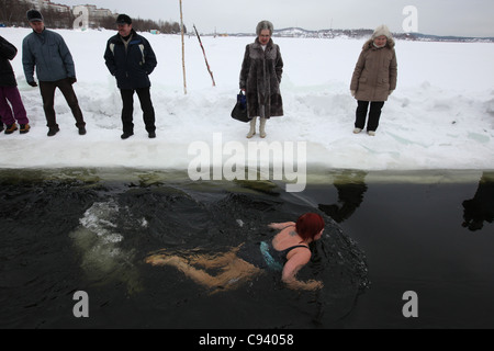 Tournament in winter swimming on the Verkh-Neyvinsky Pond near Novouralsk in the Urals Mountains, Russia. Stock Photo