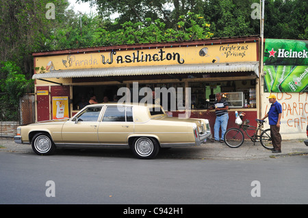 Picture shows a typical bar facing a street in the town of Ponce, Puerto Rico where people stop for a drink along the roadside. Stock Photo