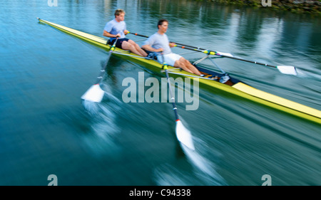 Rowers rowing in a double scull rowboat. Stock Photo