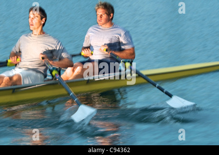 Rowers rowing in a double scull rowboat. Stock Photo