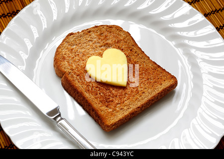 Heart shaped butter on toast Stock Photo