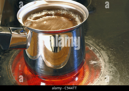 pot with armenian coffee on the cooking stove Stock Photo