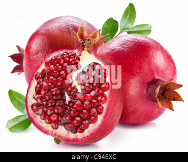 Ripe pomegranates with leaves isolated on a white background. Stock Photo