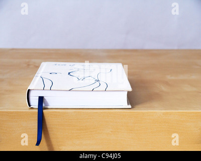 Closed book with bookmark on table Stock Photo