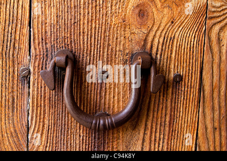 Ibiza traditional rusted iron door handle on weathered wood Stock Photo