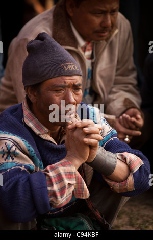 India, Meghalaya, Shillong, Bola archery gambling game, spectator smoking whilst watching the copmpetition Stock Photo