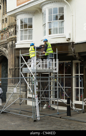 Two workmen working on a tower scaffold Stock Photo