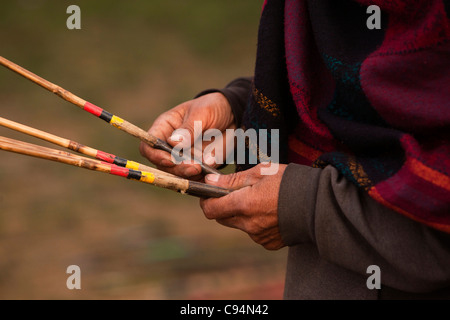 India, Meghalaya, Shillong, Bola archery gambling game, hand holding arrows Stock Photo
