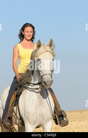 Young rider on back of Paso Fino horse in a stubble field Stock Photo