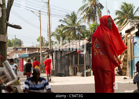 Pedestrians traverse the streets of Keko Mwanga, a slum in Dar es Salaam, Tanzania, East Africa. Stock Photo