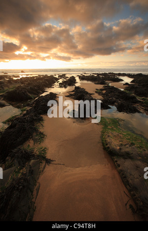 Autumn sunset over rocks at Sandymouth Bay, North Cornwall, England, UK Stock Photo